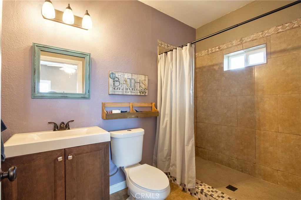 40105 Voyager Road Hemet, CA 92544 - Photo 13 of 27 a bathroom with a sink mirror vanity and toilet