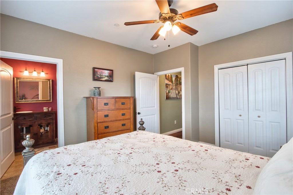 40105 Voyager Road Hemet, CA 92544 - Photo 14 of 27 a bedroom with a bed and a dresser