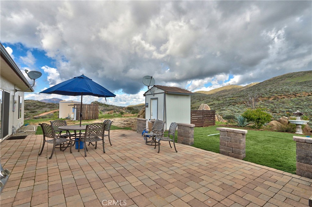 40105 Voyager Road Hemet, CA 92544 - Photo 20 of 27 a view of a patio with table and chairs under an umbrella