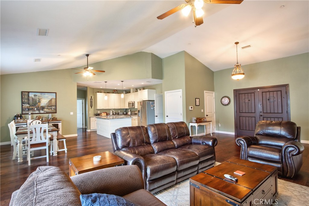 40105 Voyager Road Hemet, CA 92544 - Photo 5 of 27 a living room with furniture a ceiling fan and a chandelier