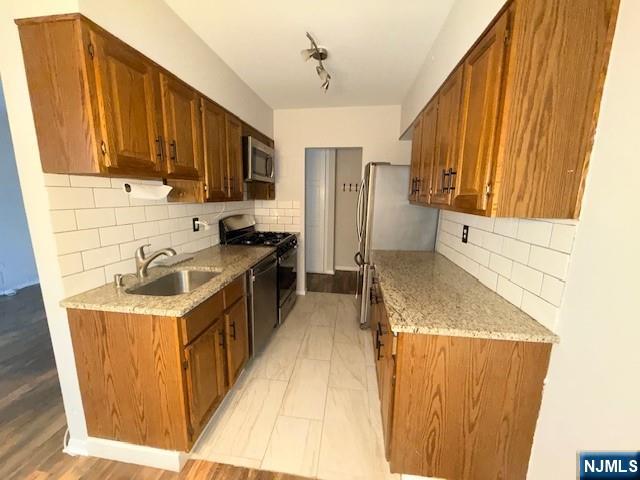 458 River Road Nutley, NJ 07110 - Photo 2 of 13 a kitchen with stainless steel appliances granite countertop a sink stove and refrigerator