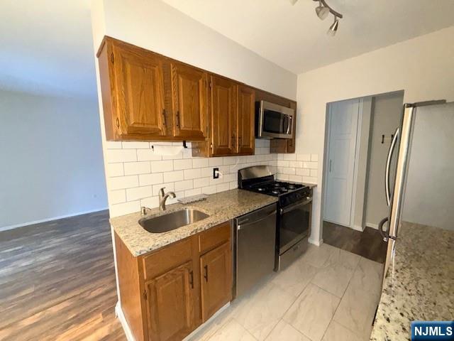 458 River Road Nutley, NJ 07110 - Photo 3 of 13 a kitchen with a sink stove and refrigerator