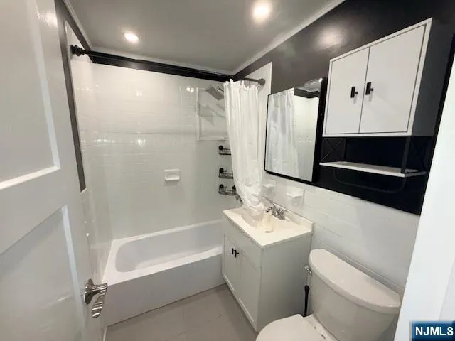 a bathroom with a bathtub shower sink and toilet