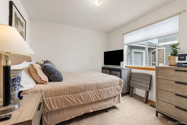 a bedroom with a bed and flat screen tv