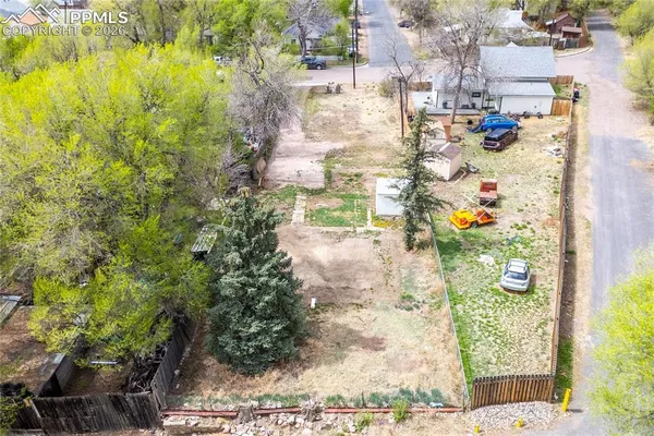 an aerial view of a house with a yard and lake view