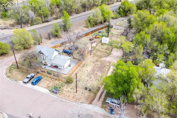 a view of a yard with a large tree