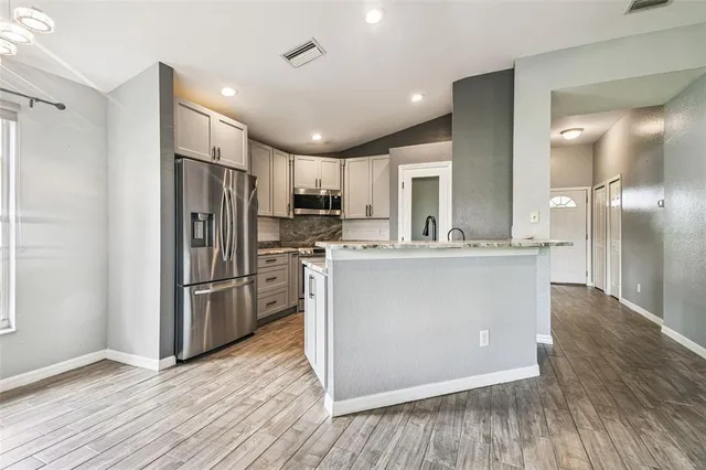a kitchen with a stove top oven and sink