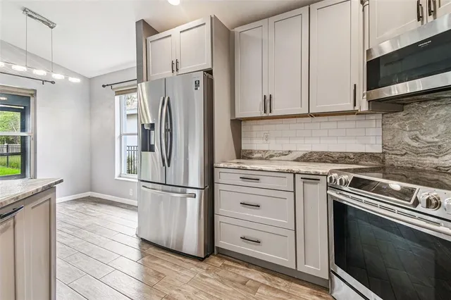 a kitchen with kitchen island a counter top space a sink appliances and cabinets