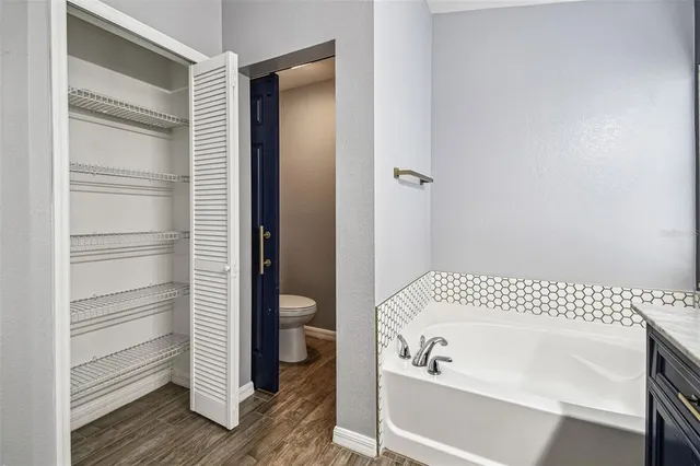 a bathroom with a sink toilet vanity and shower