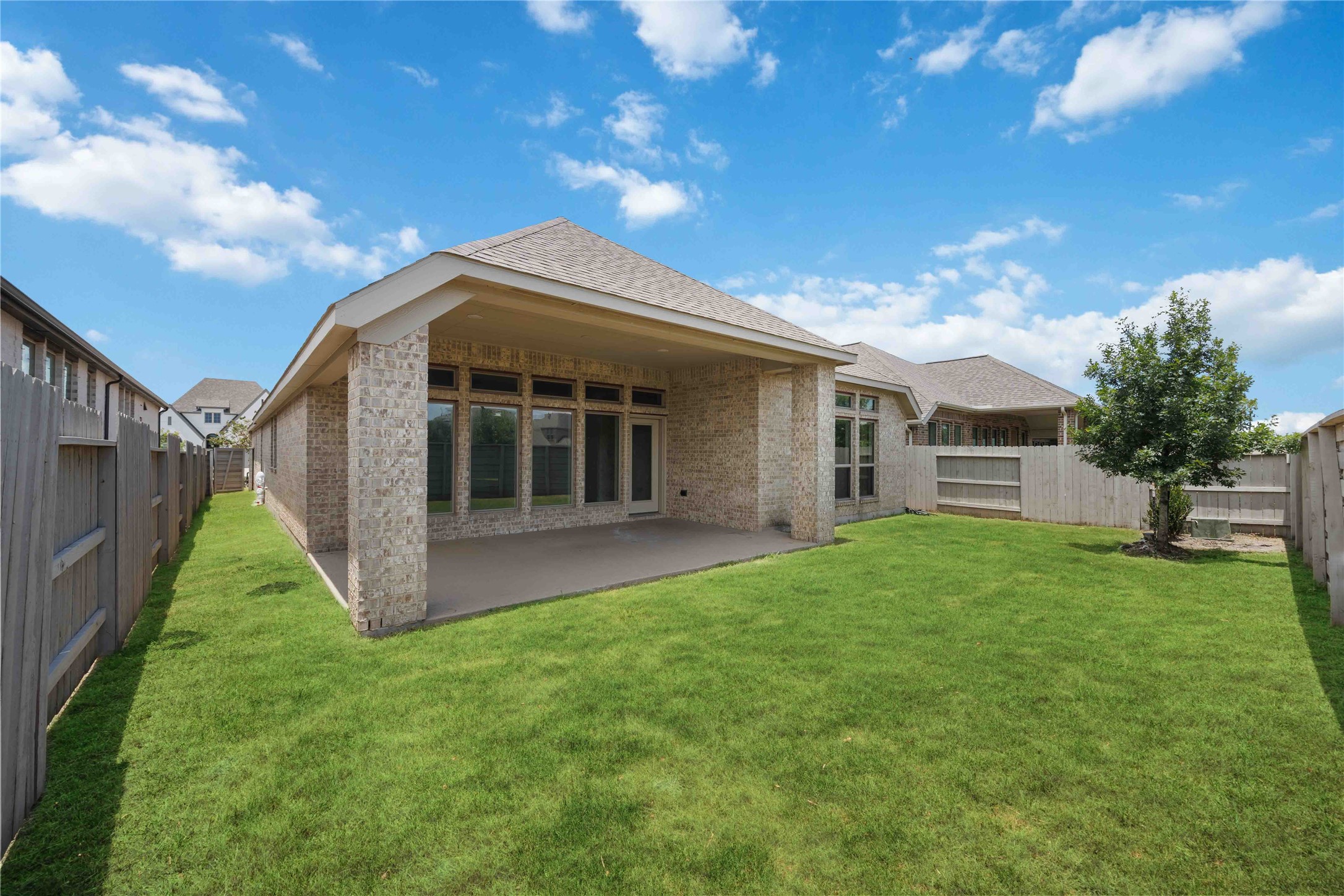 4333 Arbor Crest Lane Manvel, TX 77578 - Photo 27 of 40 An expansive, fully fenced backyard carpeted in lush green grass, presenting a completely private blank canvas ready for a garden landscape or other future additions.