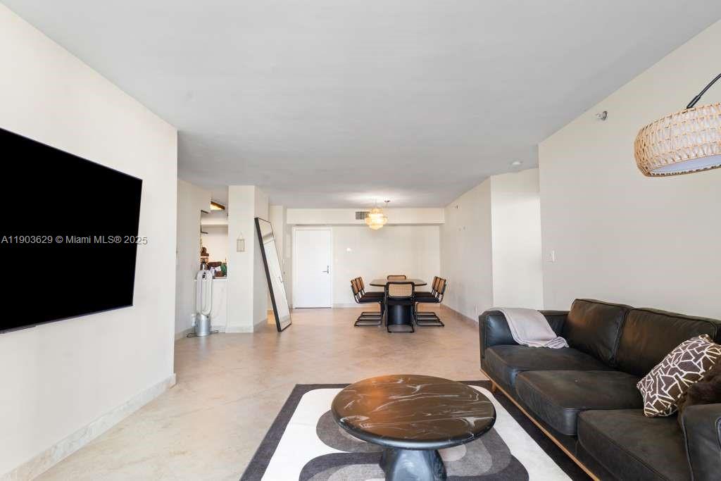 3600 Mystic Pointe Drive, Unit 1209 Aventura, FL 33180 - Photo 2 of 12 a living room with furniture and a flat screen tv