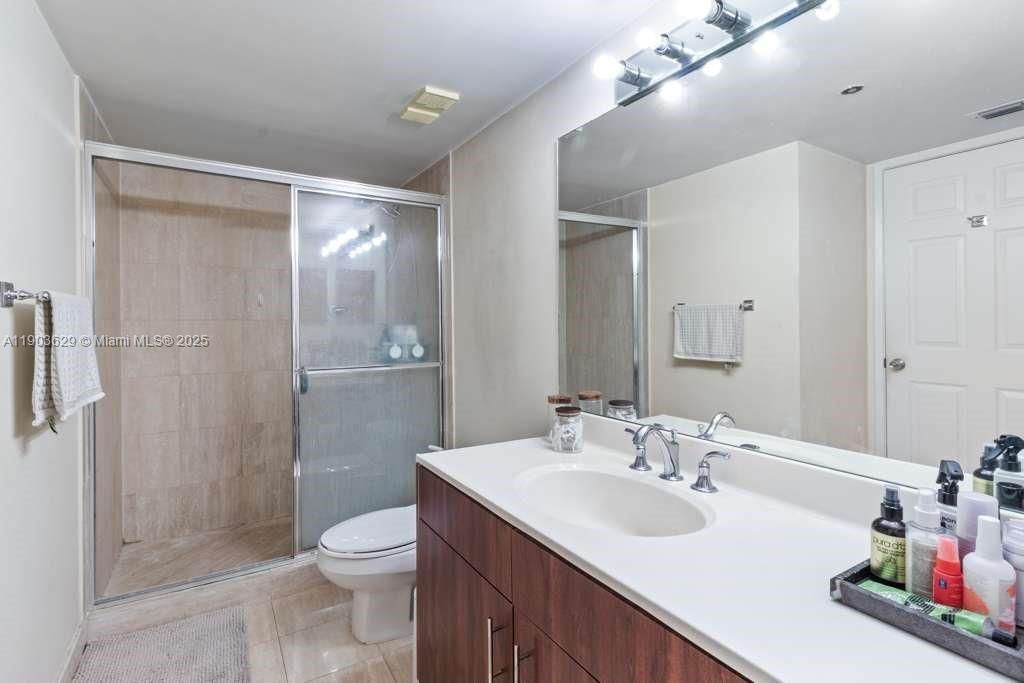 3600 Mystic Pointe Drive, Unit 1209 Aventura, FL 33180 - Photo 7 of 12 a bathroom with a sink a toilet and shower