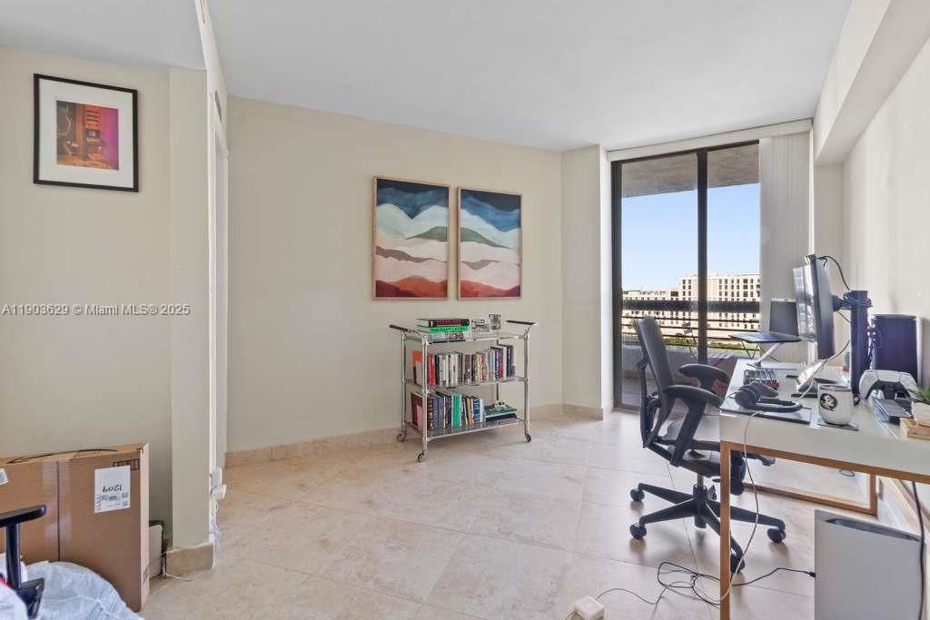 3600 Mystic Pointe Drive, Unit 1209 Aventura, FL 33180 - Photo 10 of 12 a view of a workspace with furniture and a window