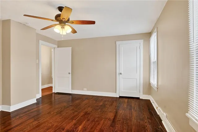 a view of room with hardwood floor and ceiling fan