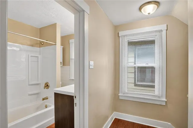 a bathroom with a bathtub and a shower