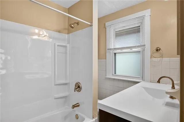 a bathroom with a bathtub and a sink