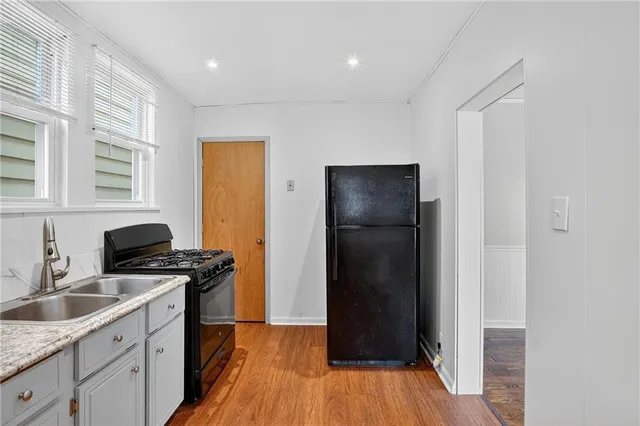 a kitchen with a refrigerator stove and sink