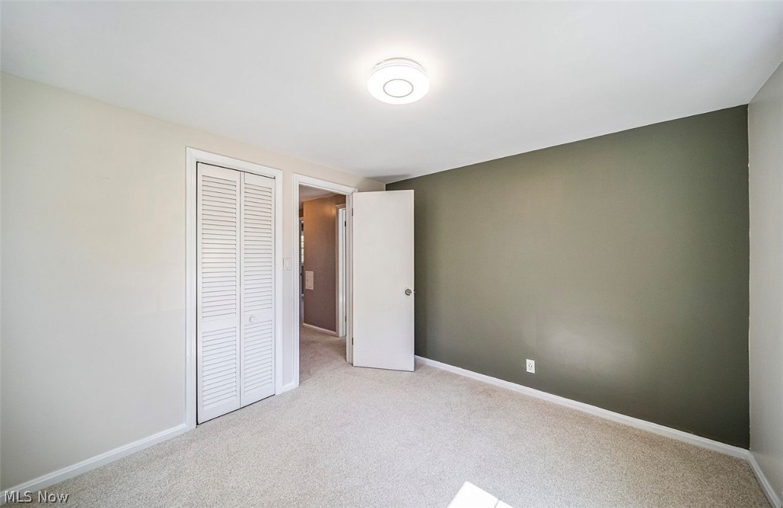 4069 Bushnell Road Cleveland, OH 44121 - Photo 25 of 39 Unfurnished bedroom featuring light carpet and a closet