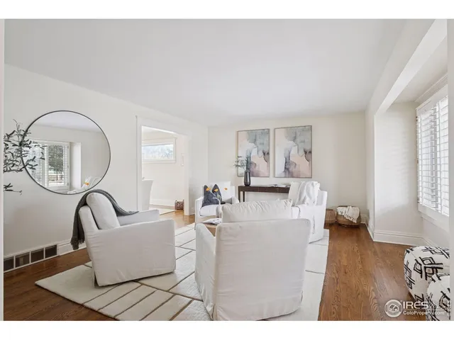 a view of a dining room with furniture wooden floor and a chandelier