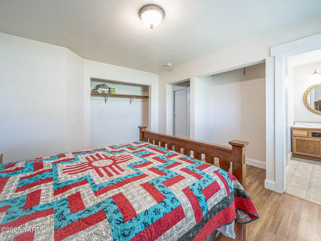 a bedroom with a bed and a table in it