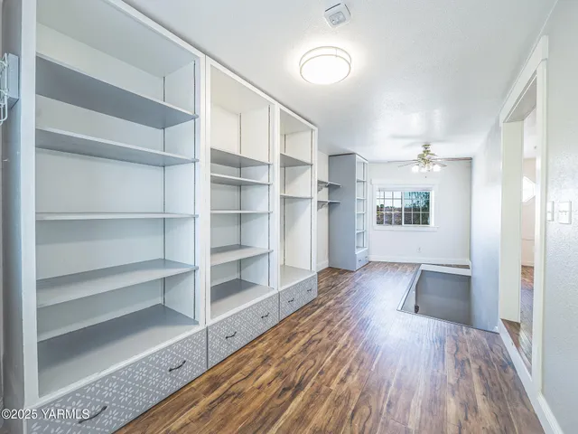 a view of a room with wooden floor and windows
