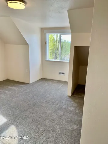 an empty room with windows and entrance