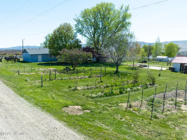 a backyard of a house with table and chairs