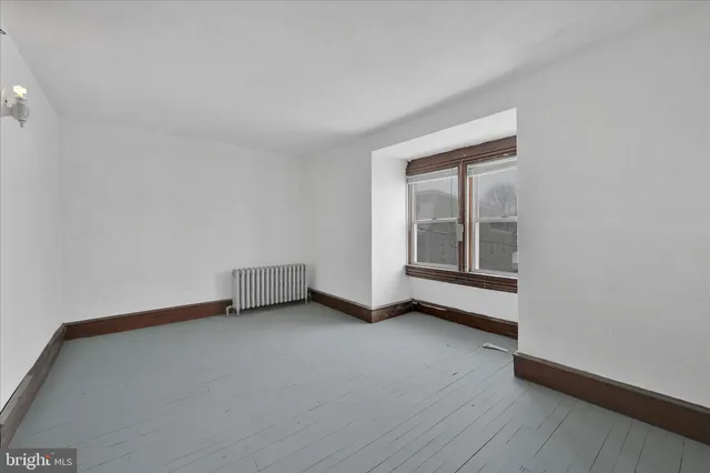 a view of a house with wooden fence