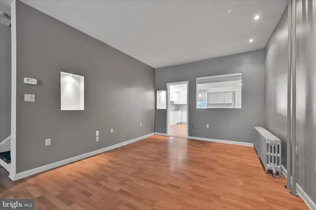 wooden floor in an empty room with a window