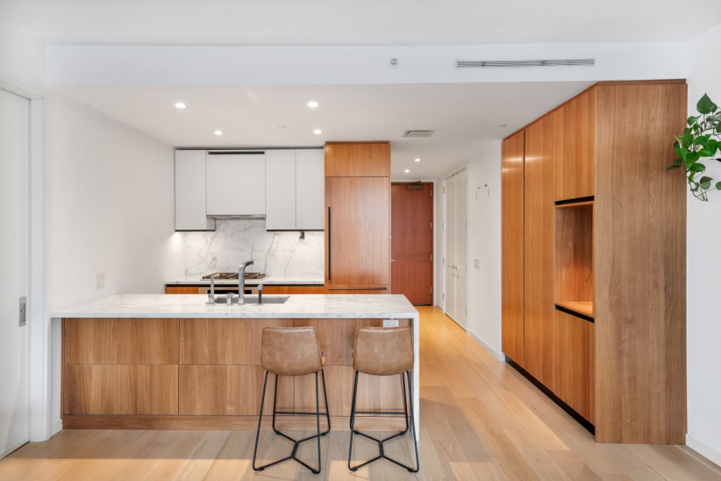 a kitchen with stainless steel appliances a refrigerator a stove a sink and a oven