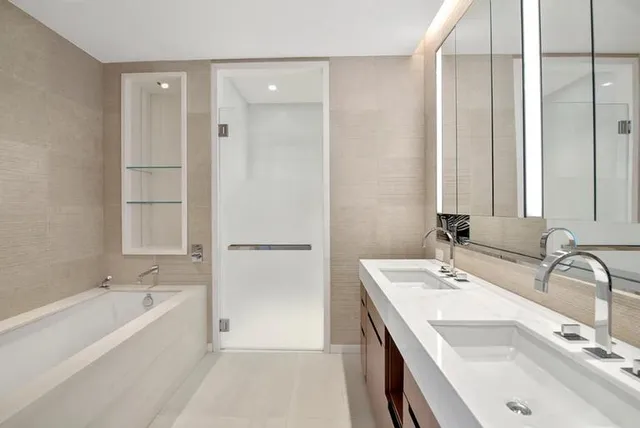 a bathroom with a tub sink and mirror