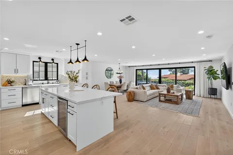 a large room with kitchen island a large window in it