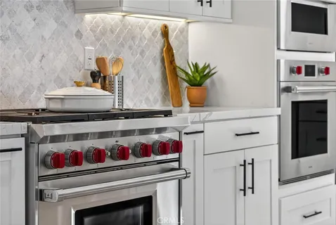 a utility room with sink and wooden floor