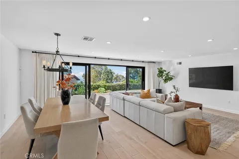 a living room with furniture a flat screen tv and a large window