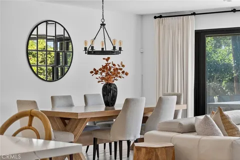 a dining room with furniture and a window