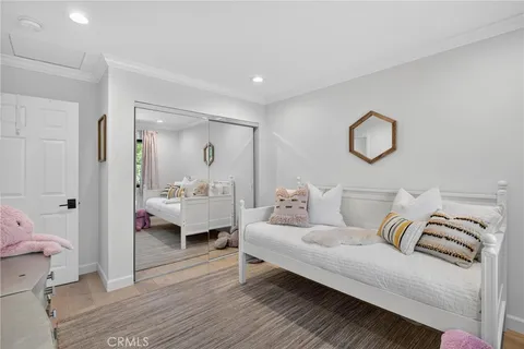 a bedroom with a bed and a large window