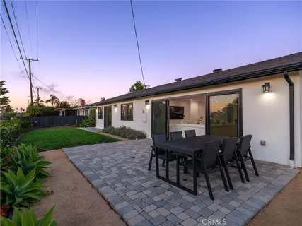 a view of a house with backyard and a sitting area