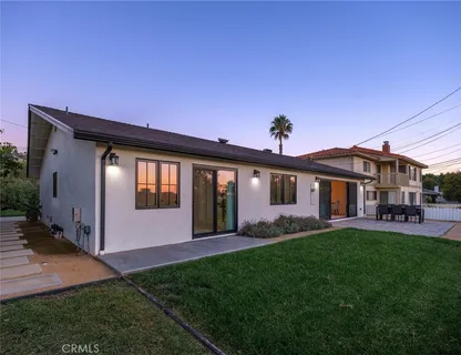 a front view of house with a garden