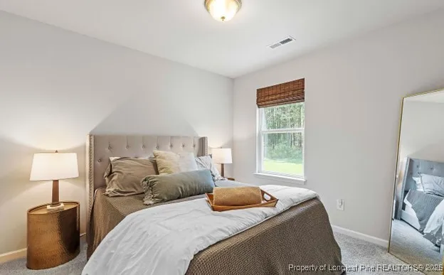 a bedroom with a bed and a lamp