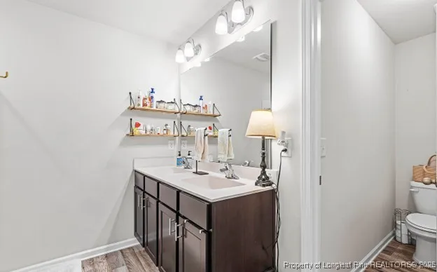 a bathroom with a sink toilet and a mirror