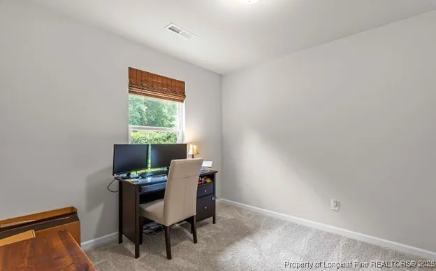 a view of a workspace with furniture