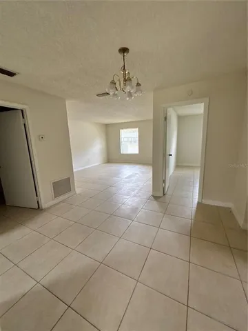 a view of a hallway with a chandelier