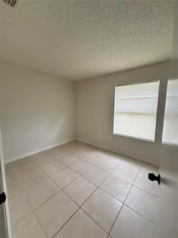 a view of an empty room and a window