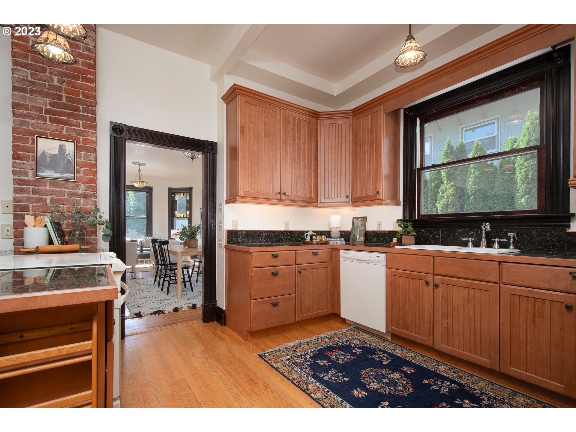 3519 Southeast Morrison Street Portland, OR 97214 - Photo 11 of 43 a kitchen with stainless steel appliances granite countertop a stove a sink and a microwave