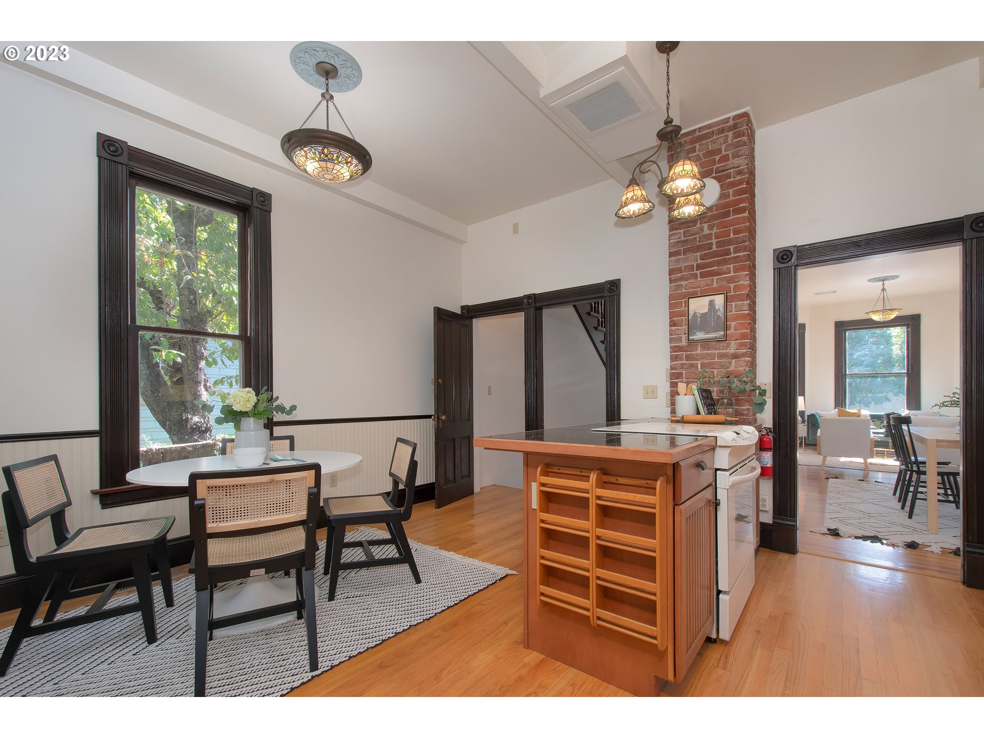 3519 Southeast Morrison Street Portland, OR 97214 - Photo 13 of 43 a living room with furniture a chandelier and a window