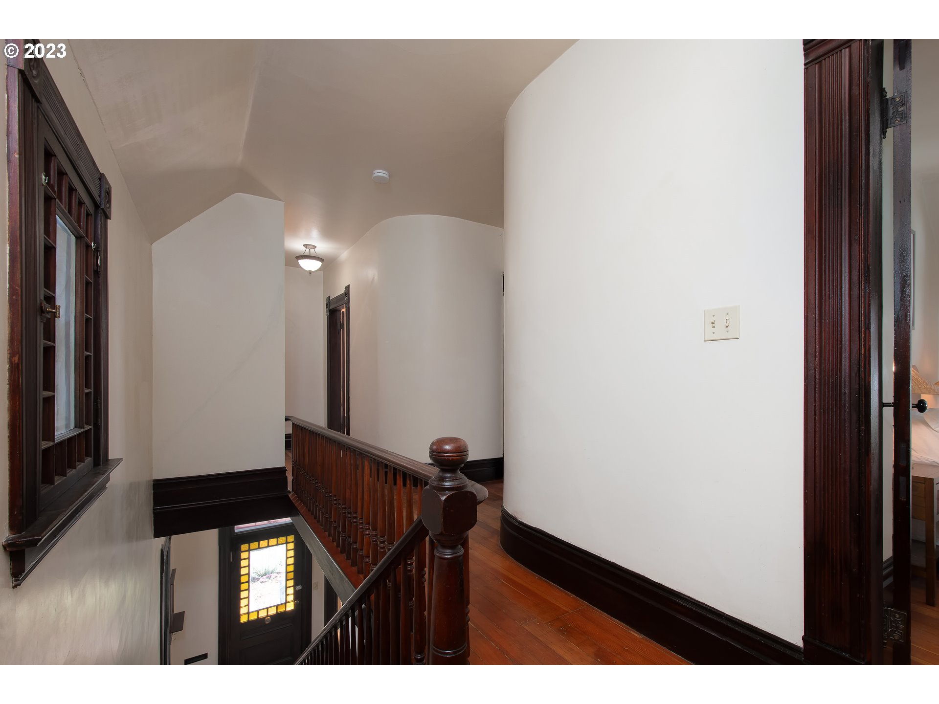 3519 Southeast Morrison Street Portland, OR 97214 - Photo 24 of 43 a view of a hallway with wooden floor and a bathroom