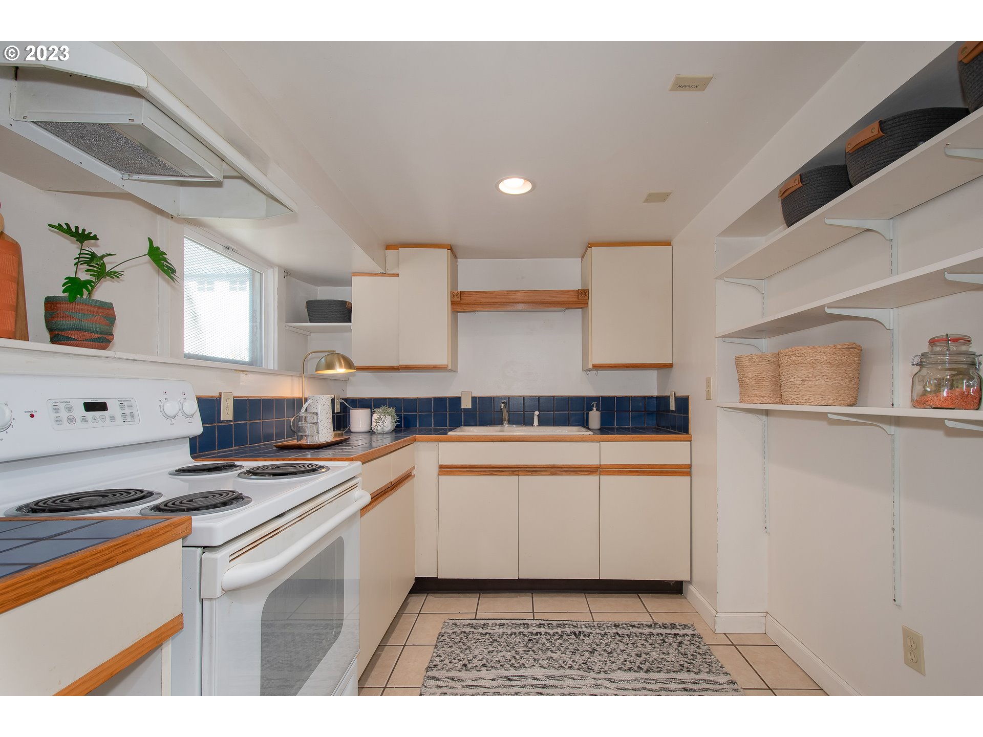 3519 Southeast Morrison Street Portland, OR 97214 - Photo 29 of 43 a kitchen with stainless steel appliances granite countertop a sink and a stove