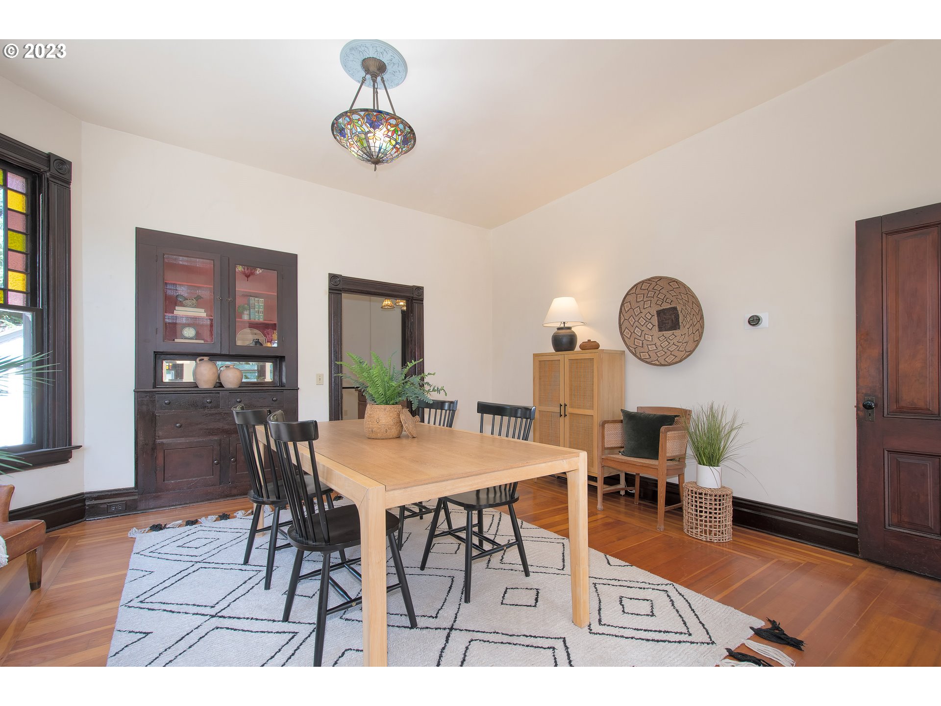 3519 Southeast Morrison Street Portland, OR 97214 - Photo 6 of 43 a view of a dining room and livingroom with furniture wooden floor and a rug