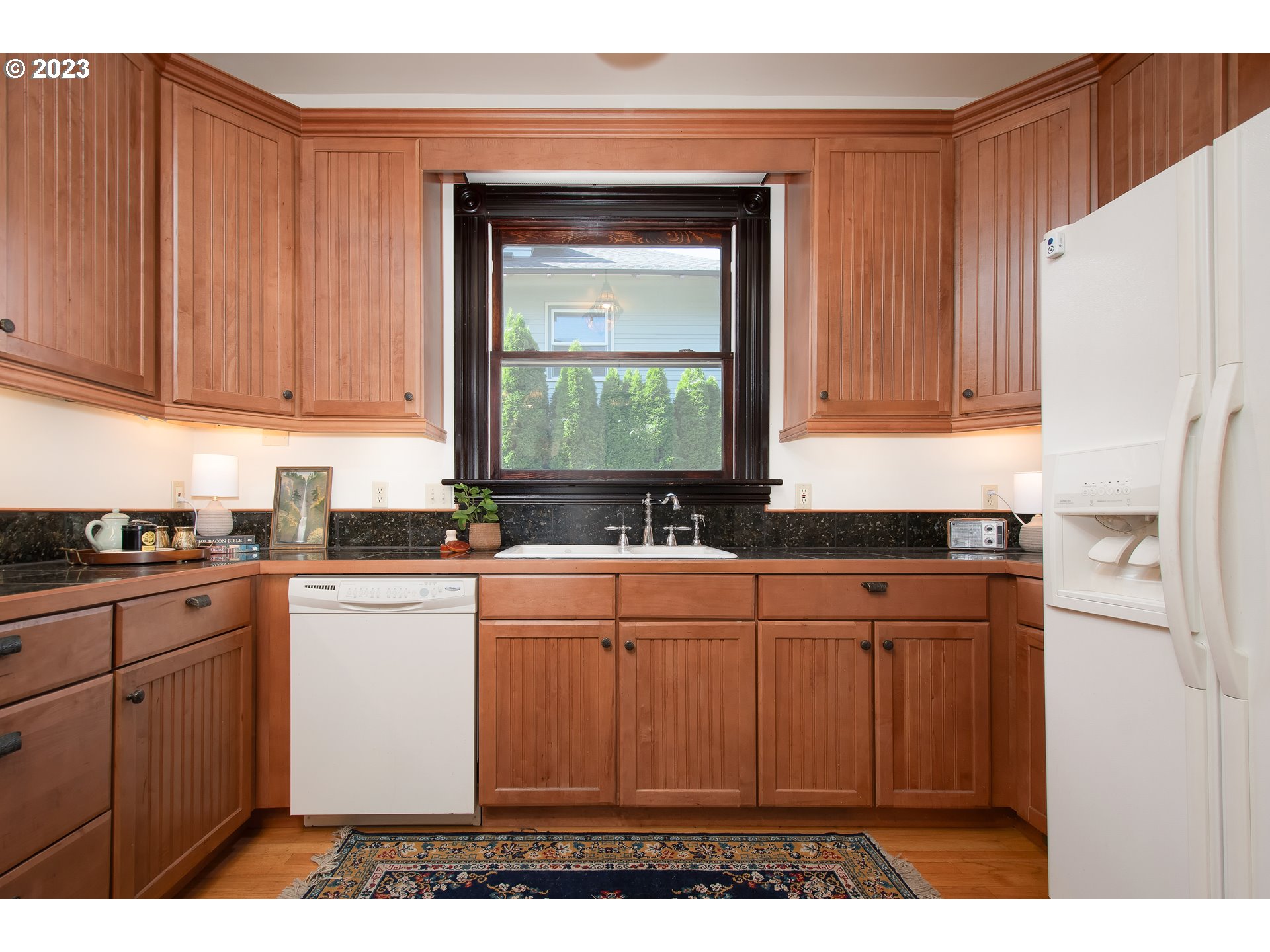 3519 Southeast Morrison Street Portland, OR 97214 - Photo 10 of 43 a kitchen with stainless steel appliances granite countertop a refrigerator sink and cabinets