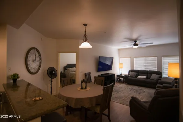 a living room with furniture a window and a clock